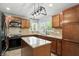 Well-appointed kitchen with wood cabinets, granite countertops, stainless steel appliances, and center island at 4023 N Arlington Ave, Indianapolis, IN 46226
