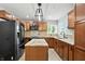 Well-lit kitchen featuring granite countertops, wooden cabinets, and modern stainless steel appliances at 4023 N Arlington Ave, Indianapolis, IN 46226