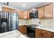 Spacious kitchen with wooden cabinets, stainless steel appliances, and granite countertops at 4023 N Arlington Ave, Indianapolis, IN 46226