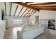 Inviting living room featuring a beamed ceiling, neutral walls, and hardwood flooring at 4023 N Arlington Ave, Indianapolis, IN 46226