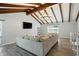 Spacious living room with vaulted ceiling, exposed beams, and a large sectional sofa at 4023 N Arlington Ave, Indianapolis, IN 46226