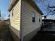Exterior home detail featuring vinyl siding, well-maintained drainage, and a glimpse of the backyard at 429 Wallace Ave, Indianapolis, IN 46201
