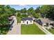Aerial view of a well-maintained property with a landscaped lawn, driveway, and charming home at 452 N Fenton Ave, Indianapolis, IN 46219