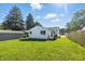 Expansive backyard with lush green grass and mature trees surrounding the perimeter at 452 N Fenton Ave, Indianapolis, IN 46219