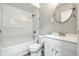 Bright bathroom featuring a shower-tub combo, vanity with storage, and modern fixtures at 452 N Fenton Ave, Indianapolis, IN 46219