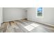 Room with laminate flooring and neutral paint at 452 N Fenton Ave, Indianapolis, IN 46219