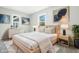 Bright bedroom with light wood furniture, neutral walls, soft textures, and decorative artwork at 452 N Fenton Ave, Indianapolis, IN 46219