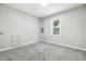 Unfurnished bedroom features neutral walls and carpeted flooring with bright natural light at 452 N Fenton Ave, Indianapolis, IN 46219