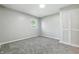 Cozy bedroom with plush carpet, natural light, and a spacious closet at 452 N Fenton Ave, Indianapolis, IN 46219
