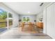 Bright dining room with hardwood floors, stylish decor, and sliding glass doors to the deck at 452 N Fenton Ave, Indianapolis, IN 46219