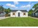 Exterior of home with fresh lawn and nearby garages at 452 N Fenton Ave, Indianapolis, IN 46219