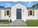 Charming home featuring a decorative security door, white siding, and wood shutters at 452 N Fenton Ave, Indianapolis, IN 46219