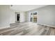 Open-concept living room showcasing vinyl plank flooring and access to the backyard at 452 N Fenton Ave, Indianapolis, IN 46219