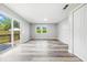 Spacious living room featuring vinyl plank flooring, a sliding glass door, and natural light at 452 N Fenton Ave, Indianapolis, IN 46219