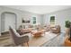 Inviting living room featuring ample seating, a large area rug, and abundant natural light at 452 N Fenton Ave, Indianapolis, IN 46219