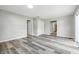 Large living room featuring vinyl plank flooring, neutral paint, and a sliding glass door at 452 N Fenton Ave, Indianapolis, IN 46219