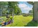 Lush backyard with mature trees, manicured lawn, and patio with seating; ideal for relaxation at 4625 Beth Ann Dr, Indianapolis, IN 46221