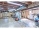 Unfinished basement with exposed beams, laundry area, and ample space for storage or customization at 4625 Beth Ann Dr, Indianapolis, IN 46221