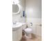 Clean bathroom with white fixtures, tiled walls, and a decorative shelf at 4625 Beth Ann Dr, Indianapolis, IN 46221