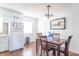 Bright dining area featuring a wooden table, four chairs and a modern chandelier at 4625 Beth Ann Dr, Indianapolis, IN 46221
