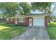 Well-maintained brick home with an attached one-car garage and a verdant front lawn at 4625 Beth Ann Dr, Indianapolis, IN 46221