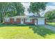 Charming single-story brick home featuring a well-manicured lawn and attached garage at 4625 Beth Ann Dr, Indianapolis, IN 46221