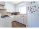 Clean kitchen featuring white cabinets, laminate counters and updated appliances at 4625 Beth Ann Dr, Indianapolis, IN 46221