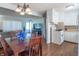 Open concept dining and kitchen area with white cabinets and hardwood flooring at 4625 Beth Ann Dr, Indianapolis, IN 46221