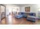 Inviting living room with hardwood floors, a comfortable gray sectional, and open dining area at 4625 Beth Ann Dr, Indianapolis, IN 46221