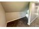 This attic room has neutral paint, neutral carpet, and a large, angled ceiling at 492 S Livingston Ave, Indianapolis, IN 46241
