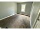 This bedroom has a neutral color scheme and carpeted flooring at 492 S Livingston Ave, Indianapolis, IN 46241