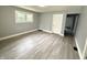 This bedroom has a neutral color scheme, a large window, and light woodgrain flooring at 492 S Livingston Ave, Indianapolis, IN 46241