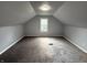 Attic-style bedroom features new carpet, gray paint and lots of natural light at 492 S Livingston Ave, Indianapolis, IN 46241