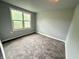 This bedroom has a neutral color scheme and carpeted flooring at 492 S Livingston Ave, Indianapolis, IN 46241