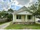 Charming home featuring green trim, covered porch, and beautifully maintained front lawn at 492 S Livingston Ave, Indianapolis, IN 46241
