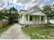 Charming home with a gravel driveway, covered front porch, and well-maintained lawn at 492 S Livingston Ave, Indianapolis, IN 46241