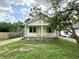 Charming home with a covered front porch, attractive green trim, and well-kept lawn at 492 S Livingston Ave, Indianapolis, IN 46241