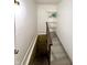 Hallway leading to stairwell with shelving for storage at 492 S Livingston Ave, Indianapolis, IN 46241