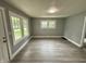 Bright, spacious living room with gray walls and modern light gray wood-look flooring at 492 S Livingston Ave, Indianapolis, IN 46241
