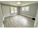 Bright, airy living room with stylish gray walls, and modern light gray wood-look flooring at 492 S Livingston Ave, Indianapolis, IN 46241