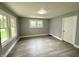 Bright, open living room featuring modern gray walls, and stylish wood-look flooring at 492 S Livingston Ave, Indianapolis, IN 46241