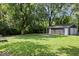 Spacious backyard with a detached garage and lush greenery at 5407 Adelaide St, Indianapolis, IN 46203