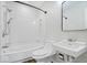 This updated bathroom features a shower-tub combo and modern fixtures at 5407 Adelaide St, Indianapolis, IN 46203