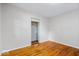 This cozy bedroom features gleaming hardwood floors and a convenient closet space at 5407 Adelaide St, Indianapolis, IN 46203