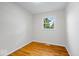 This bright bedroom features hardwood floors and a window with green views at 5407 Adelaide St, Indianapolis, IN 46203