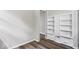 This bright bedroom features built in shelving and attractive flooring at 5407 Adelaide St, Indianapolis, IN 46203
