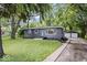 Charming single-story home featuring a well-manicured lawn and a detached two car garage at 5407 Adelaide St, Indianapolis, IN 46203
