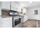 Modern kitchen with stainless steel appliances, updated cabinets, and dark backsplash at 5407 Adelaide St, Indianapolis, IN 46203