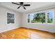 Bright living room with hardwood floors and large windows overlooking a lush yard at 5407 Adelaide St, Indianapolis, IN 46203