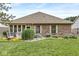 Charming backyard featuring a well-manicured lawn, brick facade, and cozy outdoor seating area at 5659 Augusta Woods Dr, Plainfield, IN 46168